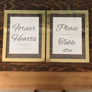 Two signs in gold frames